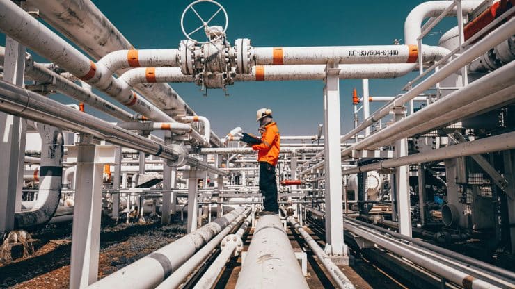 Top view male worker inspection at steel long pipes and pipe elb